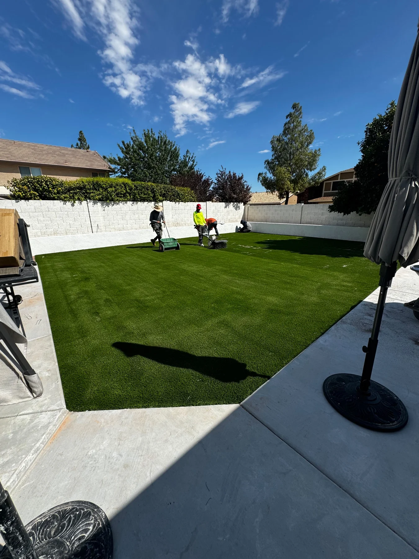 Concrete patio next to a backyard lawn and covered Arizona porch